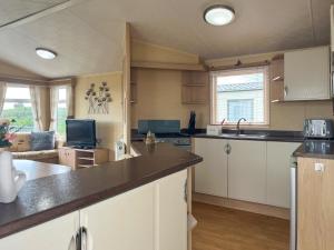 a kitchen with white cabinets and a counter top at Valley View - Uk52130 in Oakmere +6 photos