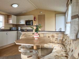 a kitchen with a table with a vase of flowers on it at Valley View - Uk52130 in Oakmere