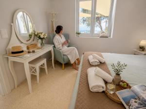 a woman sitting in a chair in a room with a mirror at Ni&Gio Sterna 6 in Parikia +46 photos