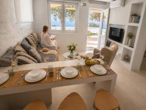a woman sitting on a couch in a living room at Ni&Gio Sterna 6 in Parikia
