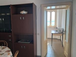 a kitchen with a door open to a room with a table at Casa MAX in Onno +68 photos