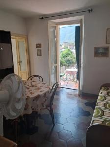a room with a table and chairs and a door to a patio at Casa MAX in Onno