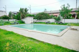a swimming pool in a yard with grass at Sam's Residence in Marilao