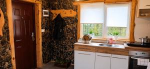 a kitchen with a sink and a window at Bieszczadzka Chatka Gosia - Off Road , Quady , Jazda Konna in Czarna +46 photos