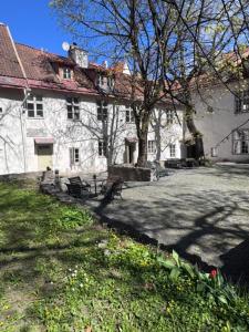 a large white building with a tree in front of it at Old town gem in Tallinn