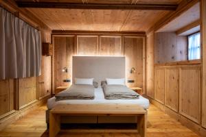 a bedroom with a bed in a wooden room at Premium Apartments Faselehof in Marlengo +110 photos