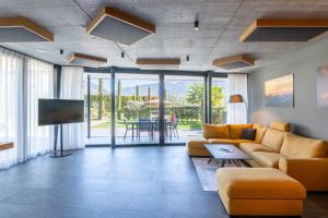 a living room with a couch and a tv at Premium Apartments Faselehof in Marlengo