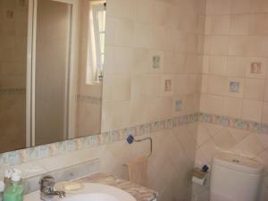 a bathroom with a sink and a toilet and a mirror at Bela Vista in Lourinhã +23 photos