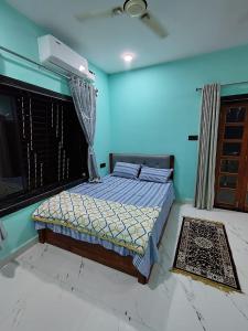 a bedroom with a bed in a blue room at Netra Kunj in Paliem
