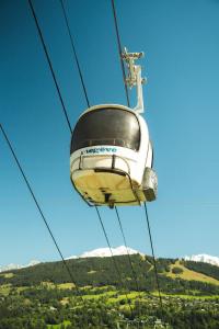 a yellow and white ski lift in the sky at Coeur de Megève in Megève