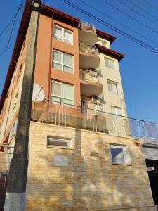 a tall building with a balcony on top of it at SEA SKY View in Byala +4 photos
