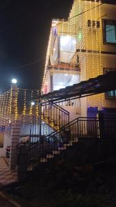 a building with christmas lights on the side of it at Netra Kunj in Paliem