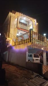 a building with lights on top of it at night at Netra Kunj in Paliem