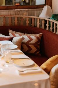 a table with plates and napkins on top at Coeur de Megève in Megève