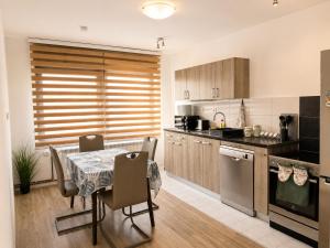 a kitchen with a table and a dining room at Central No1-Apartments in Golubac