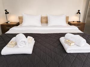 a hotel room with two beds with towels and boxes at Central No1-Apartments in Golubac