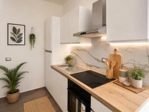 a kitchen with a sink and a counter top at Palazzo Solera Rooms in Casarano
