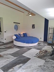 a bedroom with a bed with blue pillows at Suite Romantique in Saint-Romans