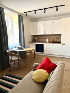 a living room and kitchen with a couch and a table at WOW Apartament in Białystok