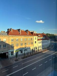 a view of a street with buildings and a road at WOW Apartament in Białystok