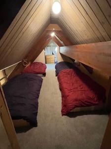 a attic room with three bunk beds in it at Historic Big Mountain Chalet Upper in Whitefish