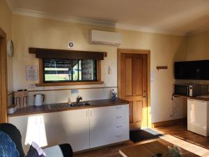 a kitchen with a sink and a counter top at Ruby's Cottage Farm Stay in Port Arthur
