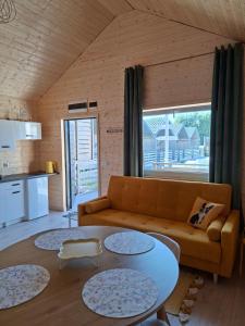 a living room with a couch and a table at Sielska Przystań in Gąski