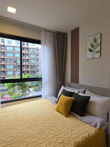 a bedroom with a bed with a large window at Cozy Minimalist apartment in Kathu +86 photos