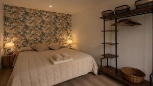 a bedroom with a bed with two towels on it at Apartamento El mirador de Olite in Olite +16 photos