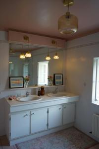 a bathroom with two sinks and a large mirror at Maison Flora Saint Jean d'Angely in Vervant +89 photos
