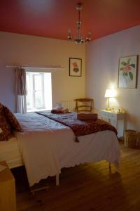 a bedroom with a large bed and a window at Maison Flora Saint Jean d'Angely in Vervant