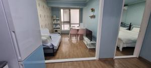 a room with a room with a bed and a mirror at Liz House in Incheon