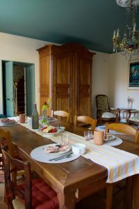 a large wooden table with plates of food on it at Maison Flora Saint Jean d'Angely in Vervant