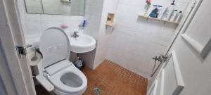 a small bathroom with a toilet and a sink at Liz House in Incheon
