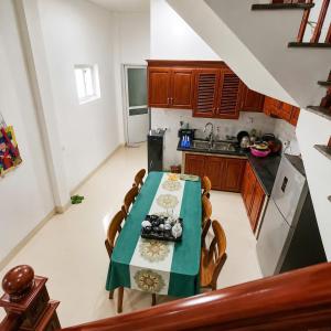 a kitchen with a table with a green table cloth at My Peaceful House Ninh Bình in Phúc Trì +9 photos