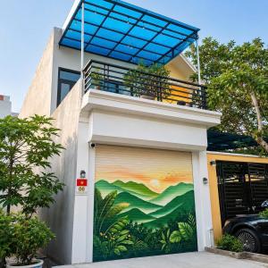a building with a painting on the garage door at My Peaceful House Ninh Bình in Phúc Trì