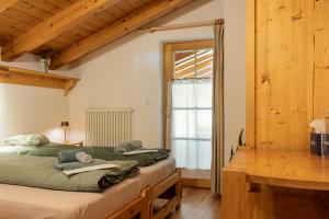 a bedroom with two beds and a window at La Culla Stube in Padola