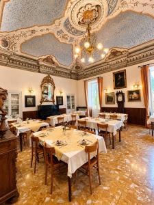 a dining room with tables and a ceiling at Albergo dell'Angelo in Pieve di Teco