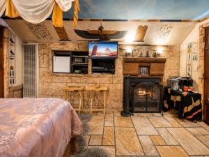 a bedroom with a fireplace and a bed and a television at Castle Wood Cottages in Big Bear Lake