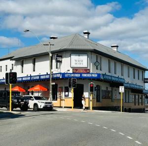 a building on the corner of a street with a traffic light at The Beaconsfield Hotel in Fremantle