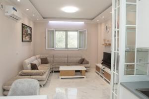 a living room with a couch and a tv at Miri House in Domje
