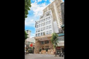 a tall white building on a city street at A25 - Premium Hotel - 95 Lò Đúc in Hanoi