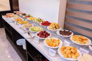 a buffet with many plates of food on a table at A25 - Premium Hotel - 95 Lò Đúc in Hanoi