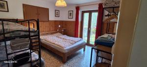 a room with a bed and a bunk bed at Il Melo in Trasquera
