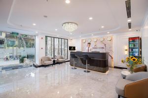 a man sitting at a piano in a living room at A25 - Premium Hotel - 95 Lò Đúc in Hanoi