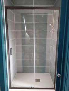 a shower with a glass door in a bathroom at Gite La maison du gardien in Marcillac-Vallon +11 photos