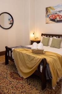 a bedroom with a bed with a yellow blanket on it at The Beaconsfield Hotel in Fremantle