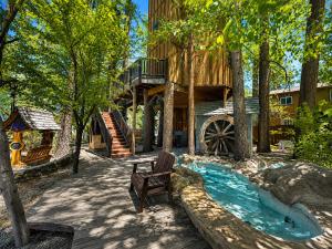 a home with a wooden house with a waterwheel at Castle Wood Cottages in Big Bear Lake