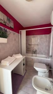 a bathroom with a toilet and a sink and a tub at La Dimora di Armida in Torricella Peligna +23 photos