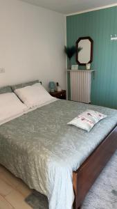 a bedroom with a large bed with a mirror at La Dimora di Armida in Torricella Peligna